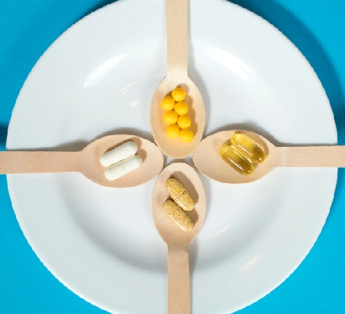Iahas-turmeric-supplement-pills-on-wooden-spoons-image